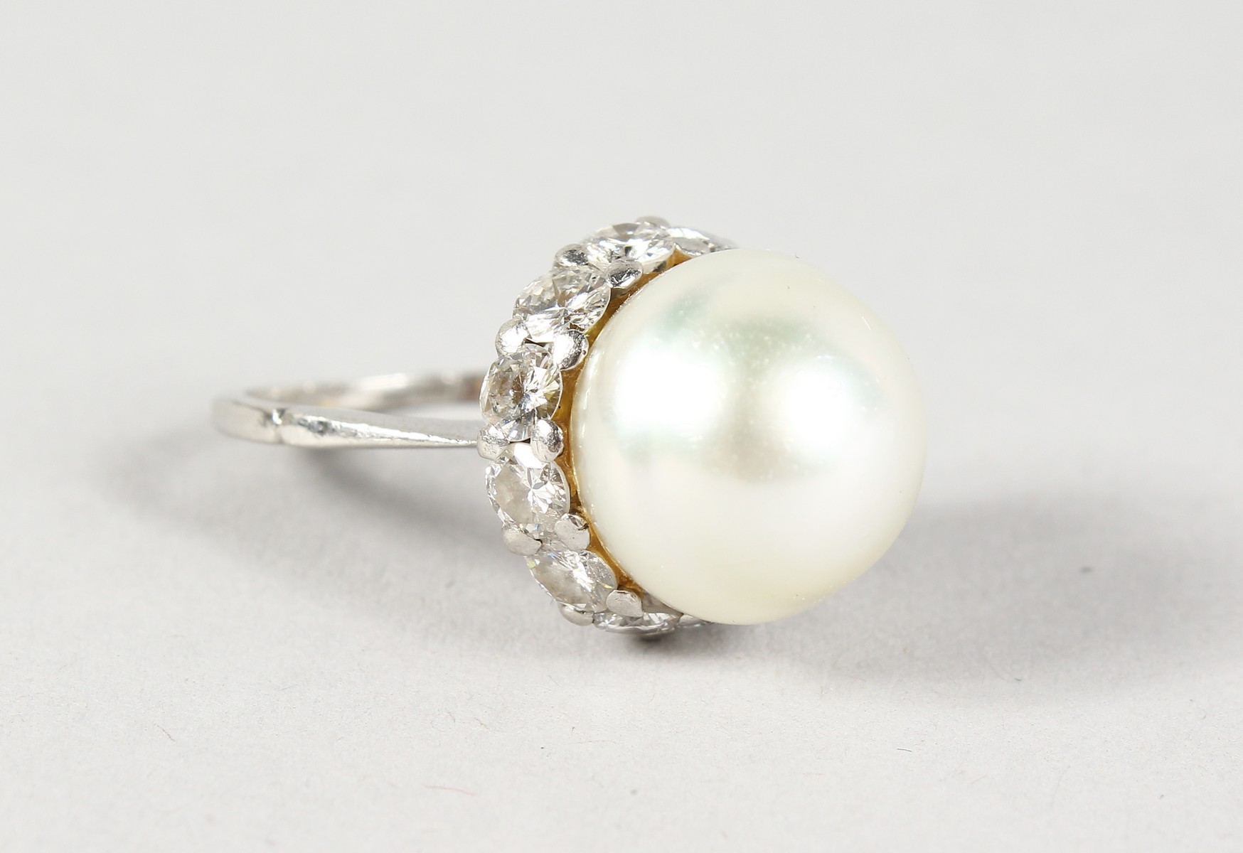AN 18CT WHITE GOLD, BAROQUE PEARL AND DIAMOND RING.