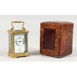 A SMALL BRASS CARRIAGE CLOCK, in leather case. 3ins high.