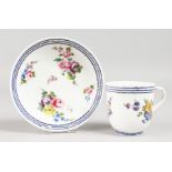 AN 18TH CENTURY SEVRES COFFEE CUP AND SAUCER, painted with flowers under three blue lines,