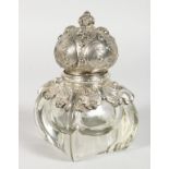 A GLASS INKWELL WITH HINGED SILVER TOP. 6ins high.