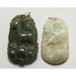 TWO CHINESE CARVED JADE PENDANTS WITH GOLD MOUNTS. 1.5ins high.
