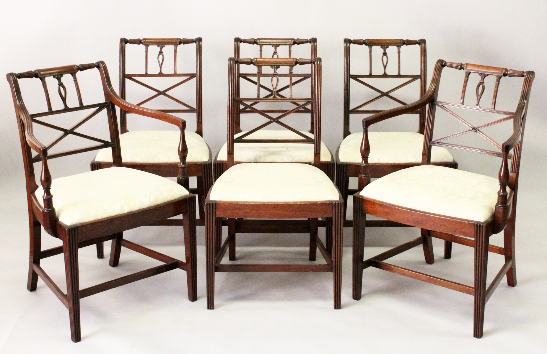 A SET OF SIX EARLY 20TH CENTURY MAHOGANY DINING CHAIRS, two with arms, all with turned and carved