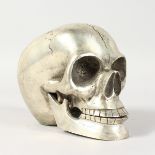 A PLATED METAL MODEL OF A HUMAN SKULL. 5ins long.