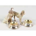 A GOOD PAIR OF SILVER PLATE DOG SALTS.