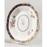 AN 18TH CENTURY DERBY DISH, with Smith's blue border painted with flowers, blue mark.
