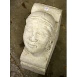 A RECONSTITUTED STONE CORBEL OF A MANS HEAD. 19ins high x 8ins wide x 14ins deep.