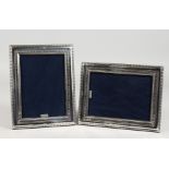 A PAIR OF MODERN SILVER PHOTOGRAPH FRAMES. 8.75ins x 7ins.