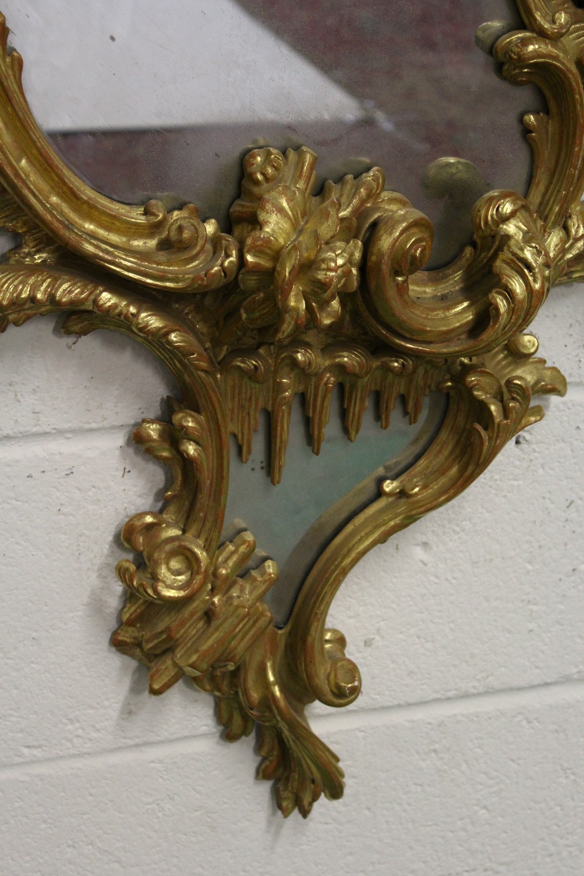 A GOOD CHIPPENDALE CARVED AND GILDED ROCOCO DESIGN MIRROR with scrolls and foliage. 4ft 10ins high x - Image 4 of 4