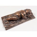 AFTER FRANCOIS DUQUESNOY A GOOD SMALL BRONZE OF A SLEEPING CHILD. 5.5ins long, on a rectangular