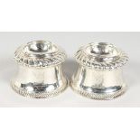 A PAIR OF VICTORIAN BRITANNIA STANDARD SILVER SALT CELLARS of Queen Anne design with gadrooned edge,