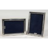 A PAIR OF MODERN SILVER PHOTOGRAPH FRAMES. 7ins x 5ins.