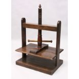 A 19TH CENTURY OAK TABLE TOP CLOTHES PRESS.