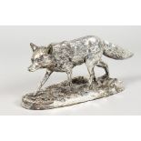A SILVER MODEL OF A FOX on a naturalistic base. 9ins long.