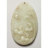 A CHINESE OVAL CARVED CELADON JADE PENDANT. 3.25ins high.