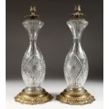A LARGE PAIR OF CUT GLASS BRASS LAMP BASES.