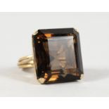 A 9CT GOLD AND LARGE TOPAZ RING.