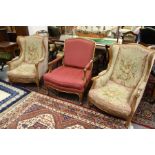 A pair of French style beech framed armchairs with needlework upholstered backs, arms and seats with