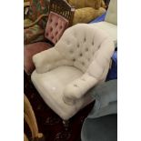 A Victorian style button upholstered armchair.