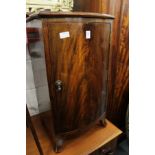 A mahogany bow fronted bedside cupboard.