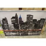 A large photographic print depicting the New York skyline.