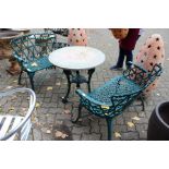 A pair of green painted cast iron modern garden benches.