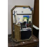 A small decoratively framed mirror.