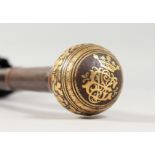 A parasol with decorative gold inlaid handle.