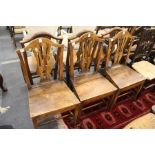 A set of six 19th century elm solid seat dining chairs with pierced vase shaped splats.