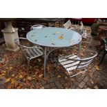 A modern circular patio table and four chairs.