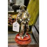 A cast metal model of Harlequin on a marble base.