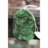 A carved jade amulet.