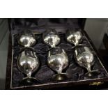 A boxed set of silver-plated miniature goblets.