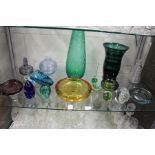 A good collection of colourful art glass items to include vases, bowls, paperweights etc.