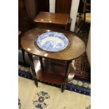 A 19th century mahogany wash stand with blue and white porcelain bowl, with two tiers united by