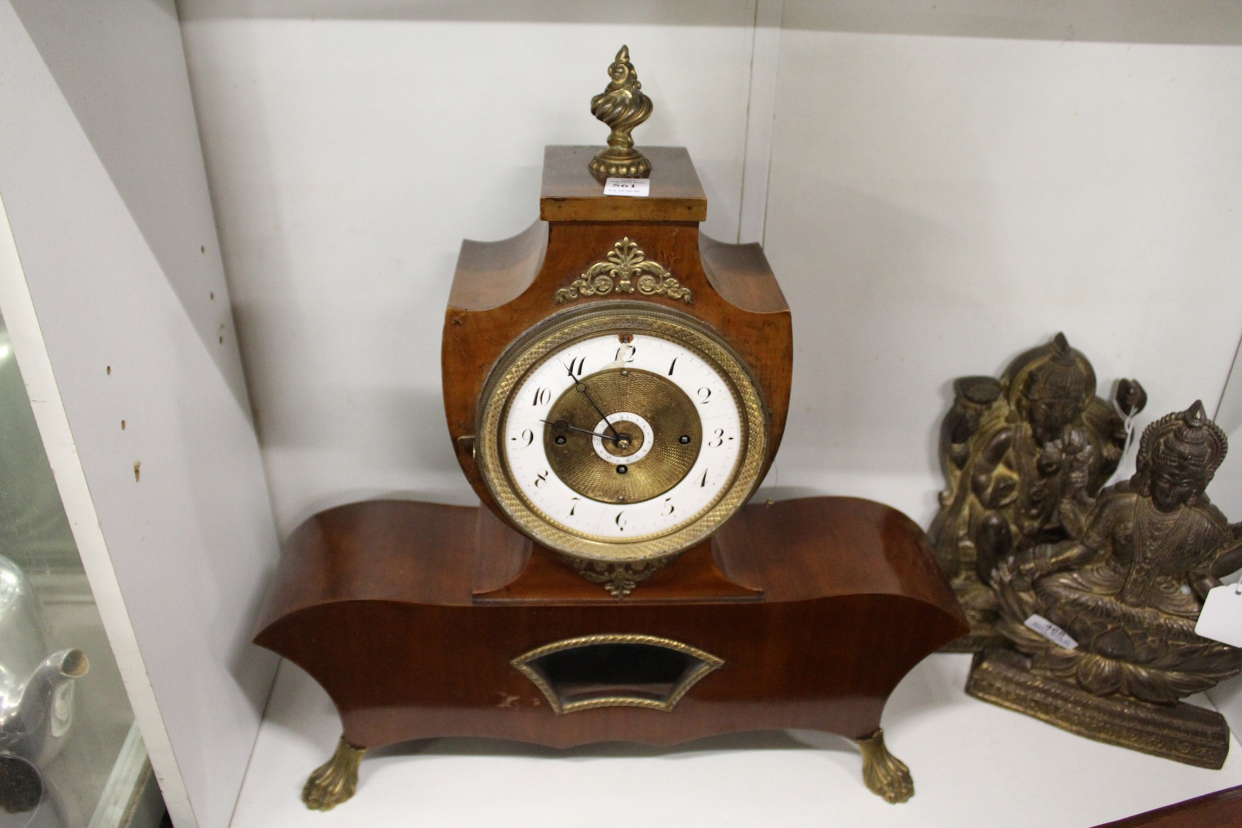 A late 19th century French mahogany mantle clock with twin porcelain dials.