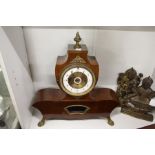 A late 19th century French mahogany mantle clock with twin porcelain dials.
