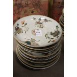 Ten Chinese floral decorated saucer dishes.
