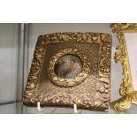 A small gilt framed enamel plaque.