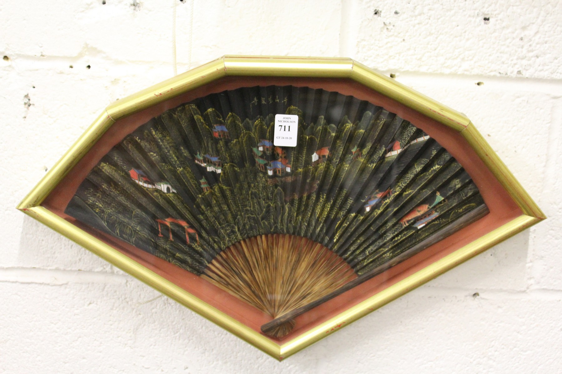 A framed and glazed Chinese fan.