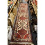 A good Persian runner / hall carpet, beige ground with eight large medallions.