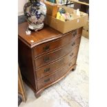 A mahogany serpentine fronted chest of drawers.