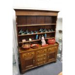 A good elm and mahogany dresser with Delft rack four central drawers flanked by two further