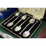 A cased set of six silver seal top coffee spoons.