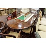 A good Regency design mahogany twin pillar dining table with two leaves.