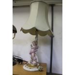 A porcelain figural table lamp.