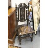 A carved oak hall chair.