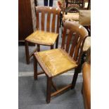 A set of six unusual walnut dining chairs with slatted backs and leather cloth upholstered seats.