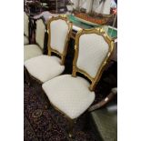A pair of French style beech framed and parcel gilded side chairs with upholstered backs and seats