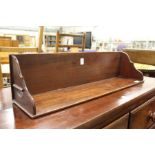 An Edwardian mahogany book trough.