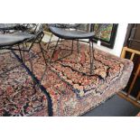 A Persian rug dark blue ground, with floral decoration.